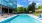 a swimming pool with a building in the background