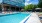 a swimming pool with chairs around it